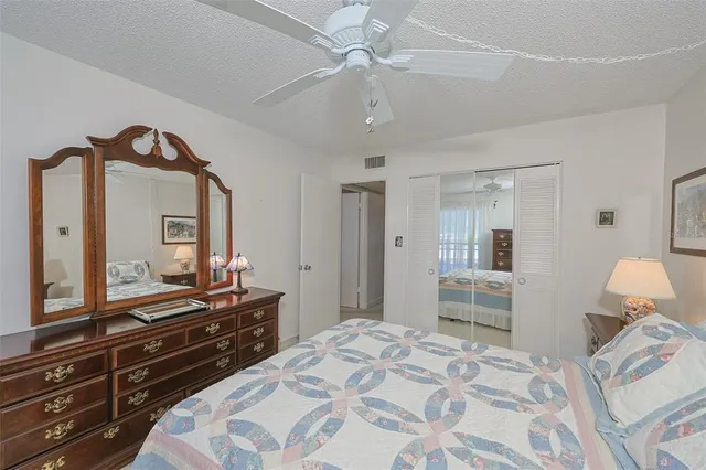 a bedroom with a bed and a dresser in it