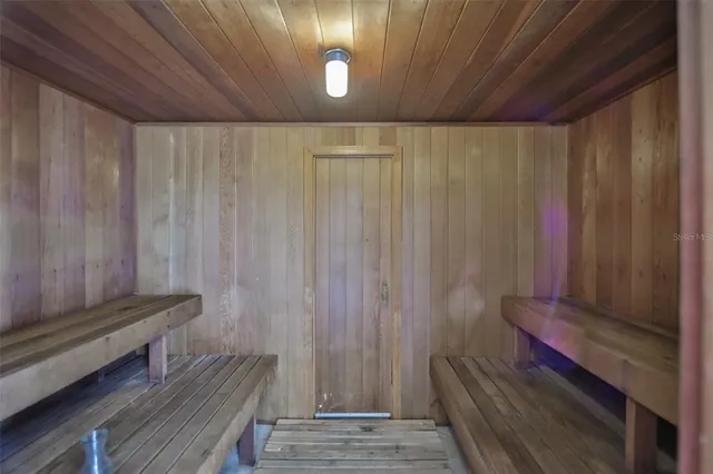 a view of wooden floor and bench in a room