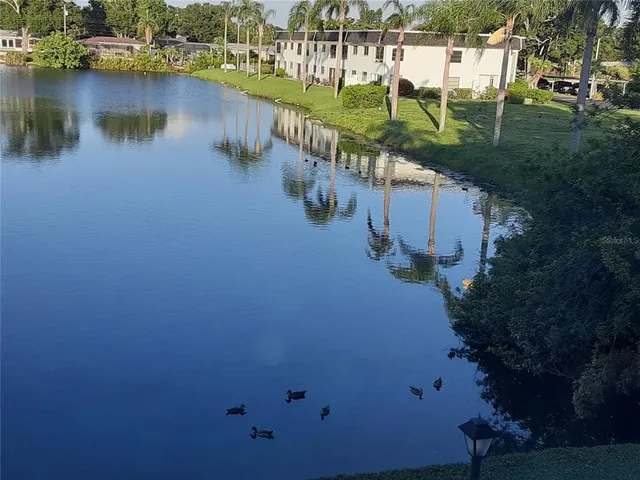 a view of a lake with a house in the background