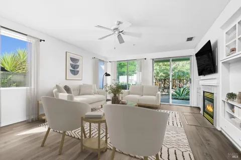 a living room with fireplace furniture and a flat screen tv