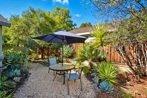 a view of a backyard with sitting area and furniture