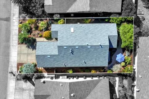 an aerial view of a house with a yard