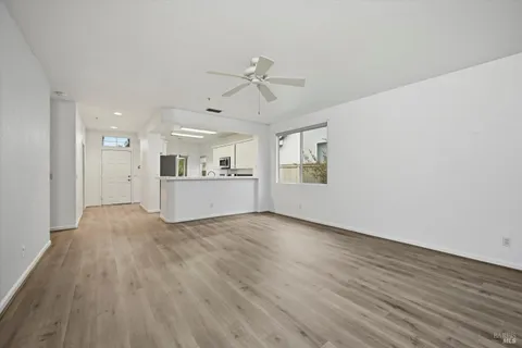 a view of a kitchen with wooden floor and a kitchen