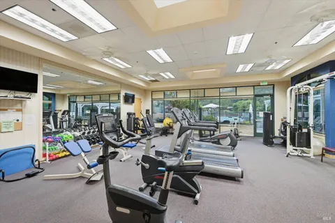 a building outdoor space with patio furniture and potted plants