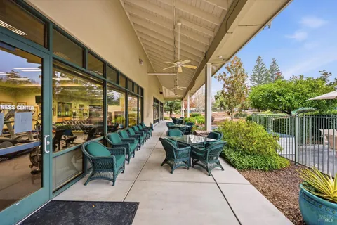 a living room with furniture a flat screen tv and a large window