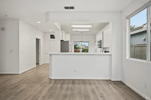 a view of kitchen with refrigerator and microwave