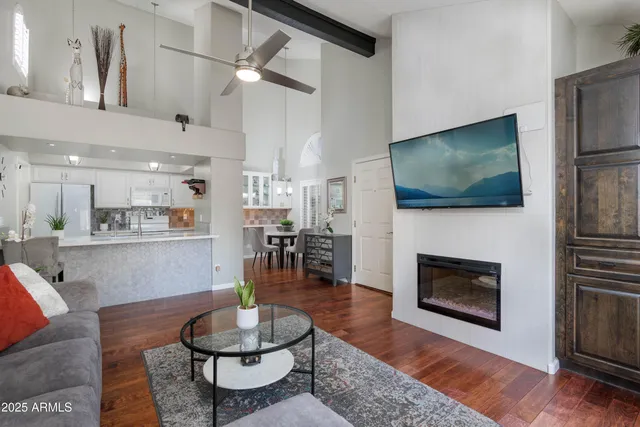 a living room with fireplace furniture and a flat screen tv