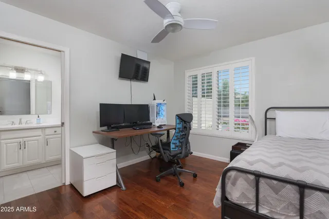 a view of a workspace with furniture and a flat screen tv