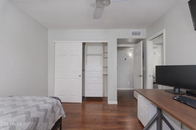 a bedroom with a bed and a flat screen tv