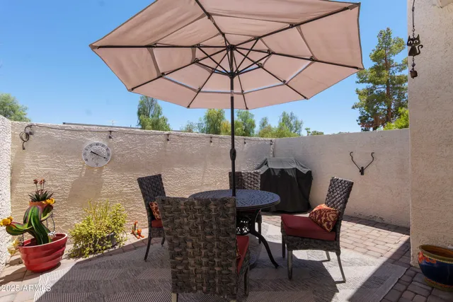 a patio with a patio table and chairs