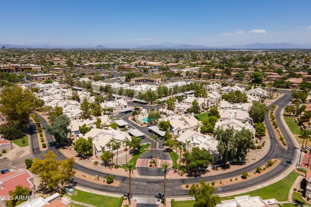 an aerial view of a house with a yard