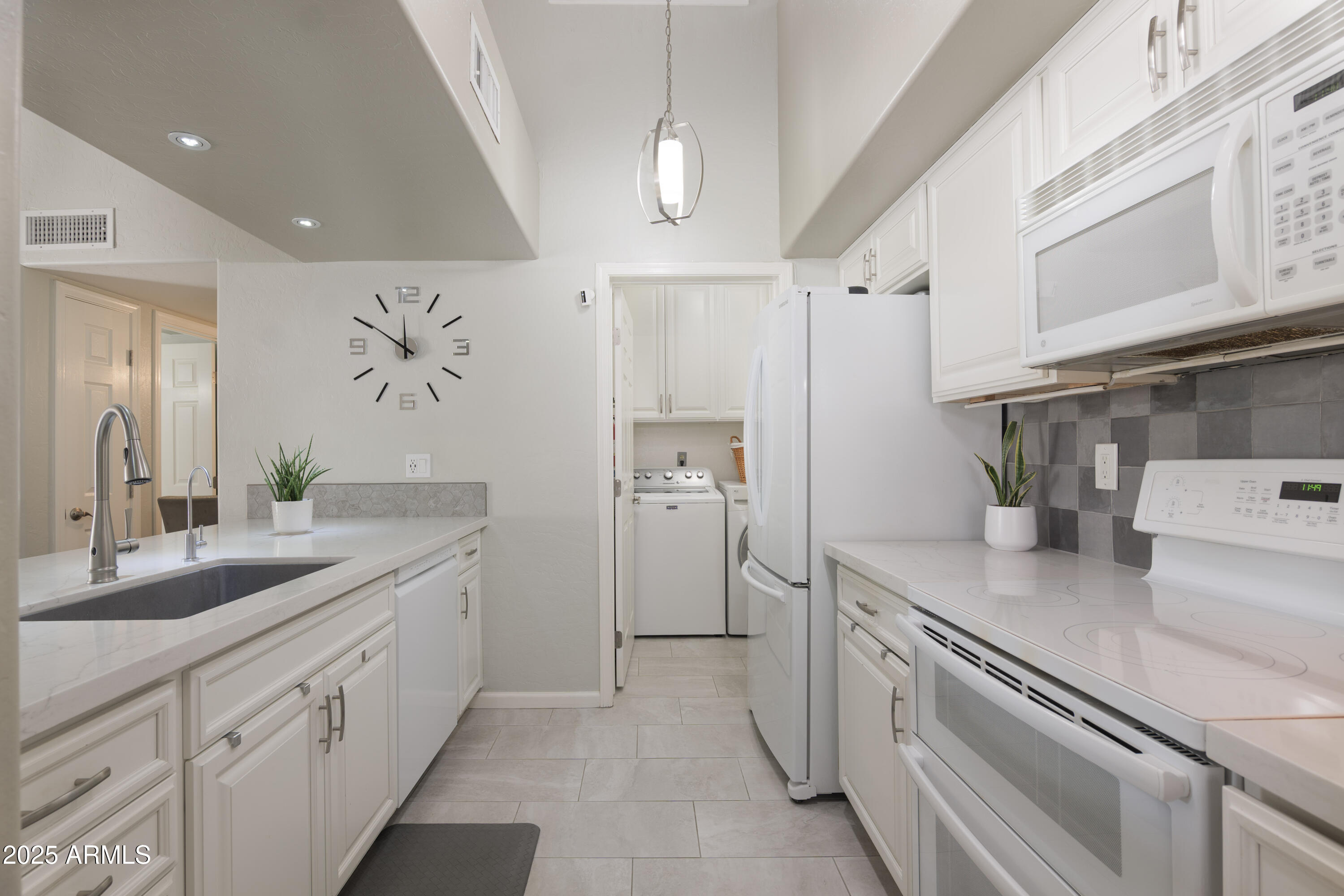 2100 West Lemon Tree Place, Unit 78 Chandler, AZ 85224 - Photo 4 of 32 a kitchen with a sink and a refrigerator
