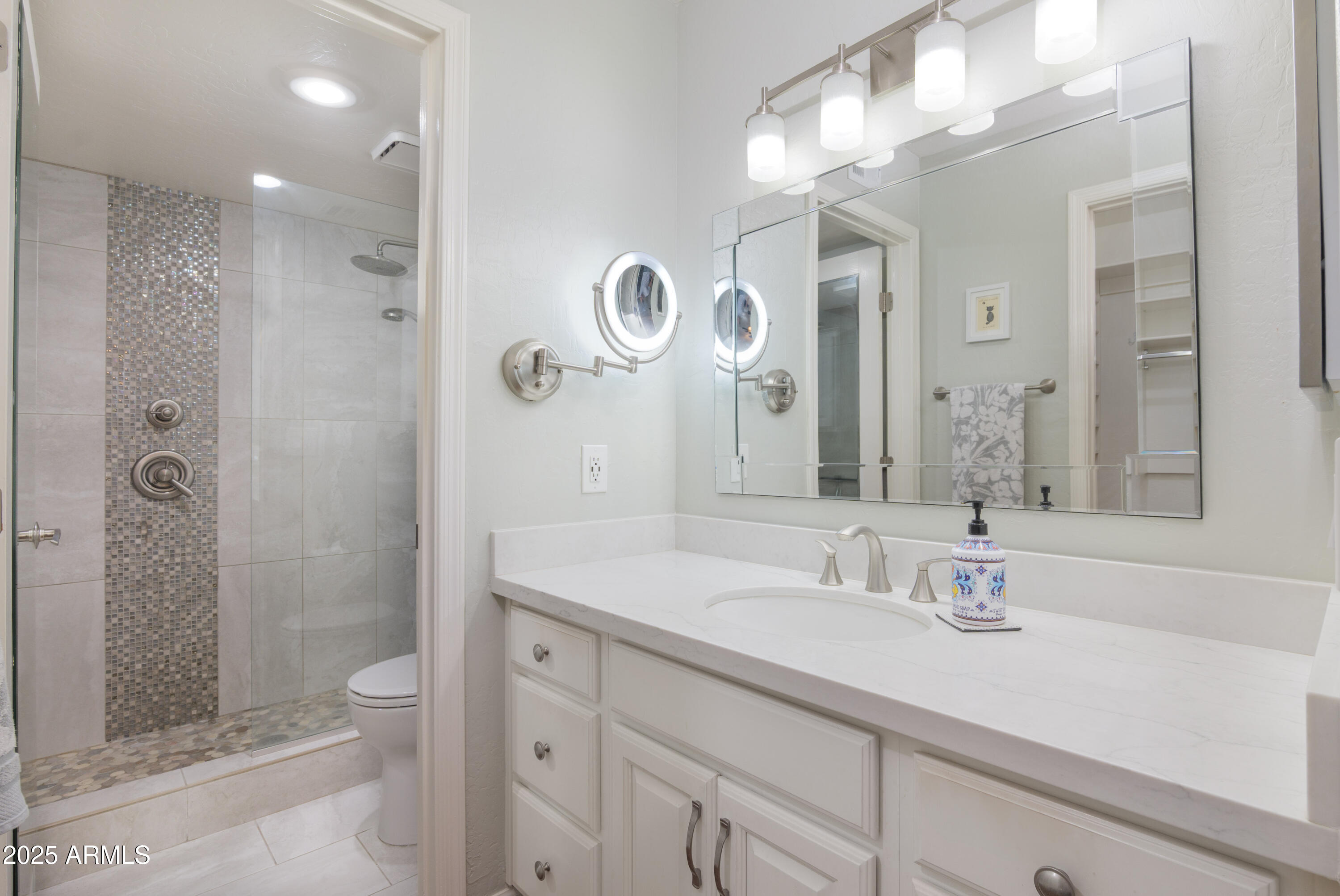 2100 West Lemon Tree Place, Unit 78 Chandler, AZ 85224 - Photo 7 of 32 a bathroom with a sink a toilet and shower