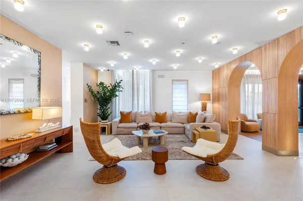 a living room with furniture and a chandelier
