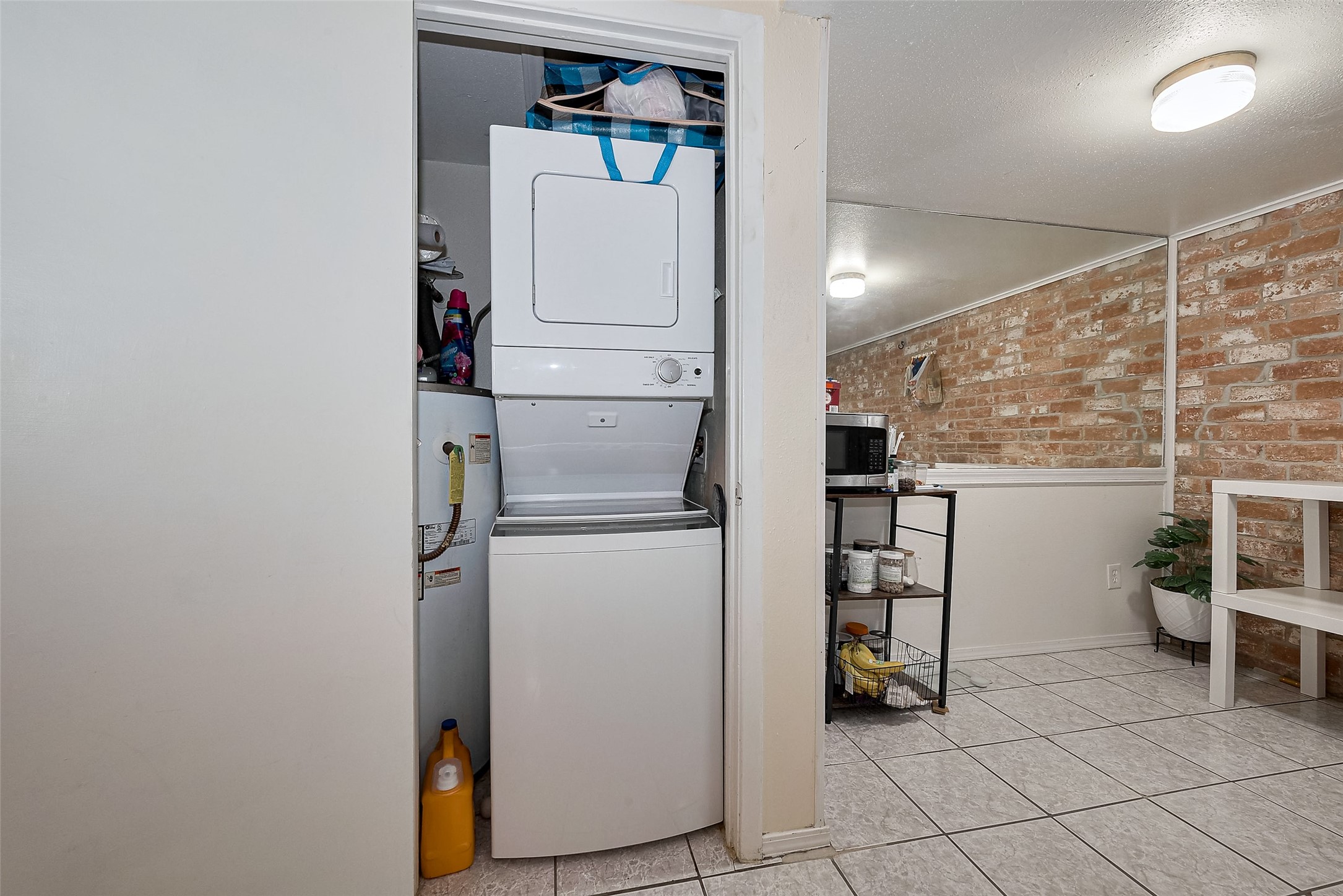 12223 Sharpview Drive Houston, TX 77072 - Photo 23 of 41 a view of washer and dryer with kitchen in the background