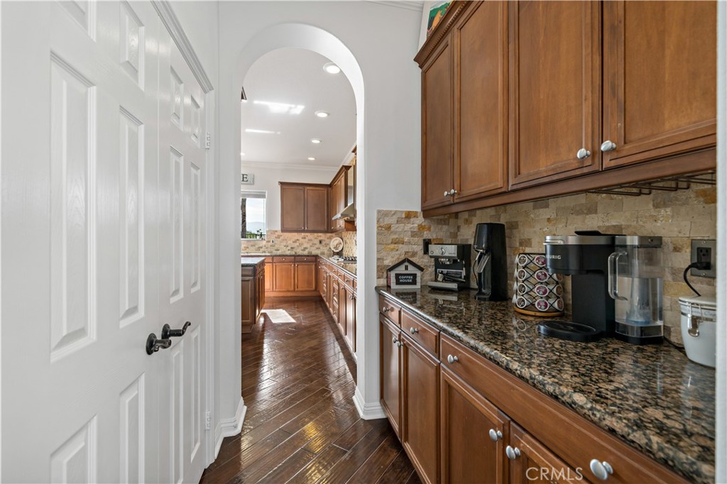 16423 Village Meadow Drive Riverside, CA 92503 - Photo 15 of 61 a view of a kitchen with stainless steel appliances granite countertop a refrigerator and a sink