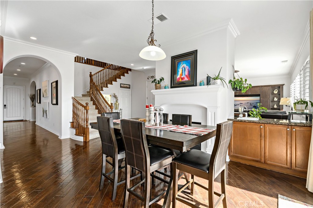 16423 Village Meadow Drive Riverside, CA 92503 - Photo 23 of 61 a view of a dining room with furniture and wooden floor