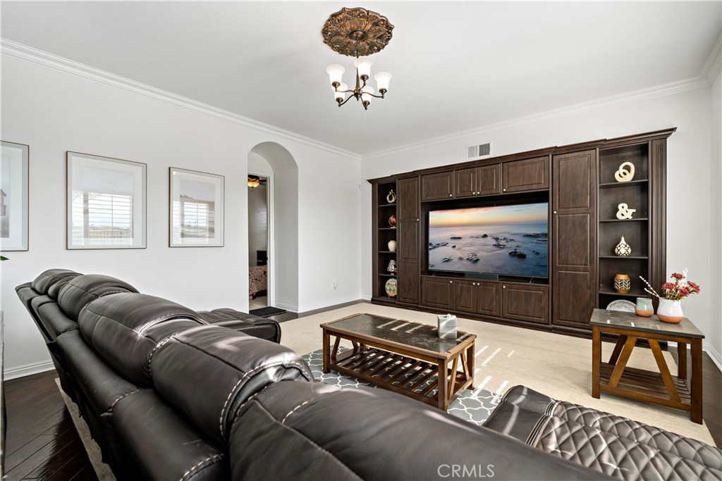 16423 Village Meadow Drive Riverside, CA 92503 - Photo 25 of 61 a living room with furniture a rug and a flat screen tv