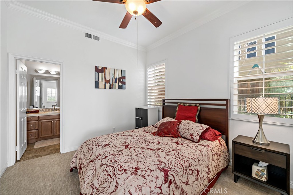 16423 Village Meadow Drive Riverside, CA 92503 - Photo 27 of 61 a bedroom with a bed and a lamp on a dresser
