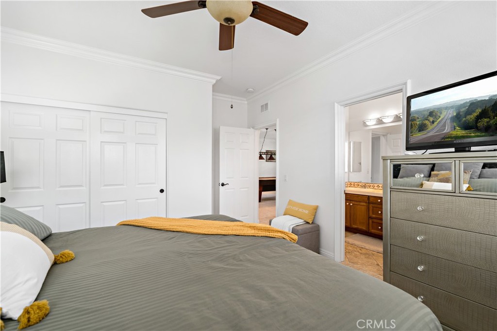 16423 Village Meadow Drive Riverside, CA 92503 - Photo 34 of 61 a bedroom with a bed and flat screen tv