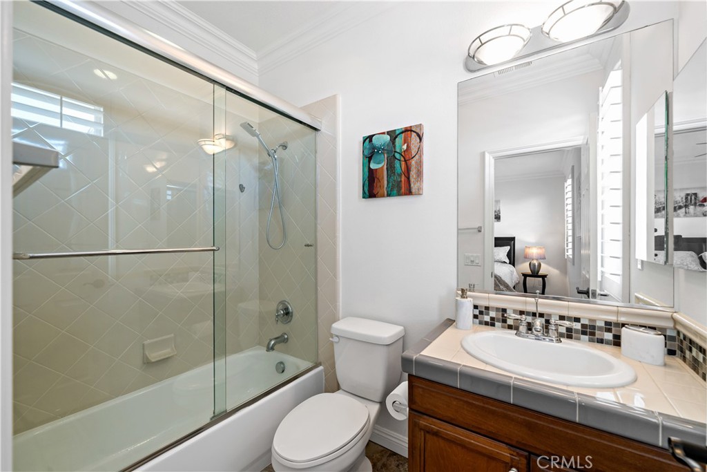 16423 Village Meadow Drive Riverside, CA 92503 - Photo 40 of 61 a bathroom with a sink a toilet and shower