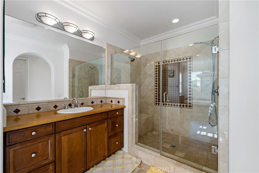 16423 Village Meadow Drive Riverside, CA 92503 - Photo 45 of 61 a bath room with a sink double vanity and a mirror