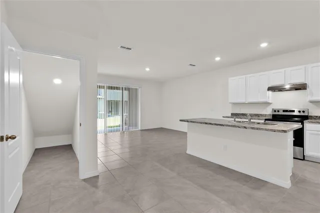 a kitchen with a sink stove and refrigerator