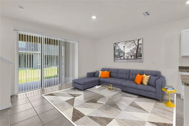 a living room with furniture and a book shelf