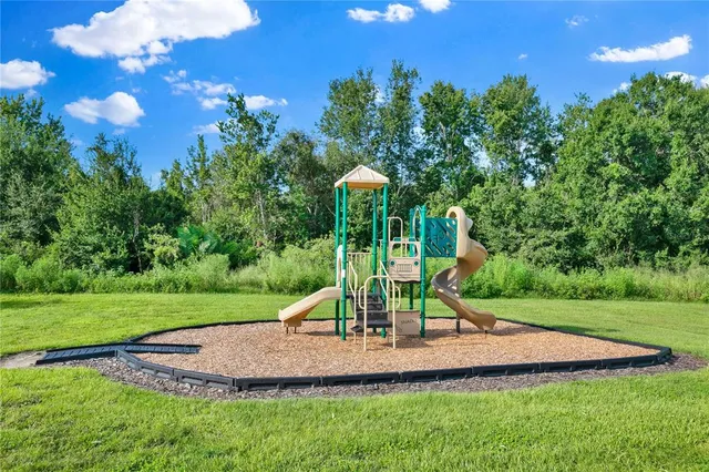 a kitchen with a sink a refrigerator and a stove top oven with wooden floor