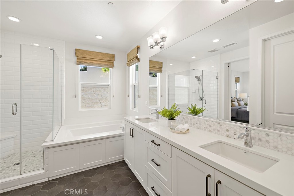 44 Jarano Street Rancho Mission Viejo, CA 92694 - Photo 14 of 65 a spacious bathroom with a granite countertop sink mirror and a bathtub