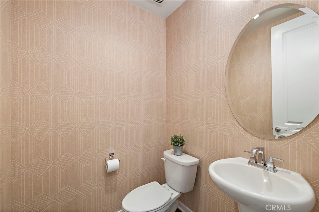 44 Jarano Street Rancho Mission Viejo, CA 92694 - Photo 19 of 65 a bathroom with a toilet sink and mirror