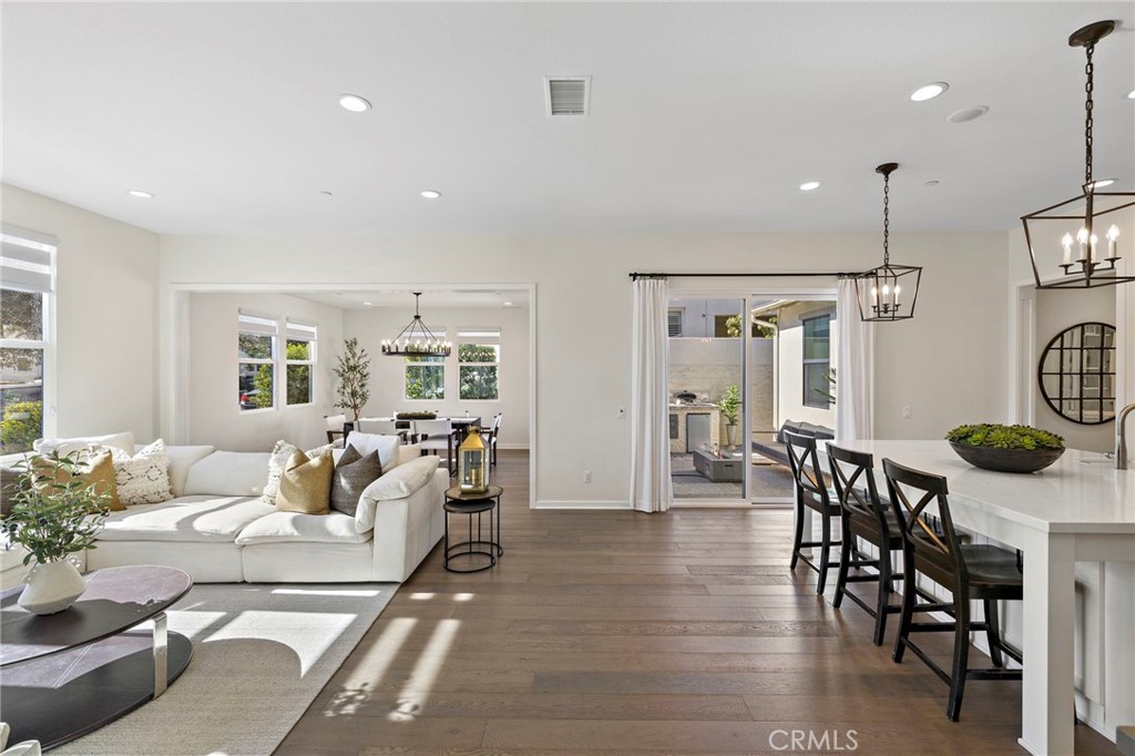 44 Jarano Street Rancho Mission Viejo, CA 92694 - Photo 2 of 65 a living room with furniture a dining table and chairs