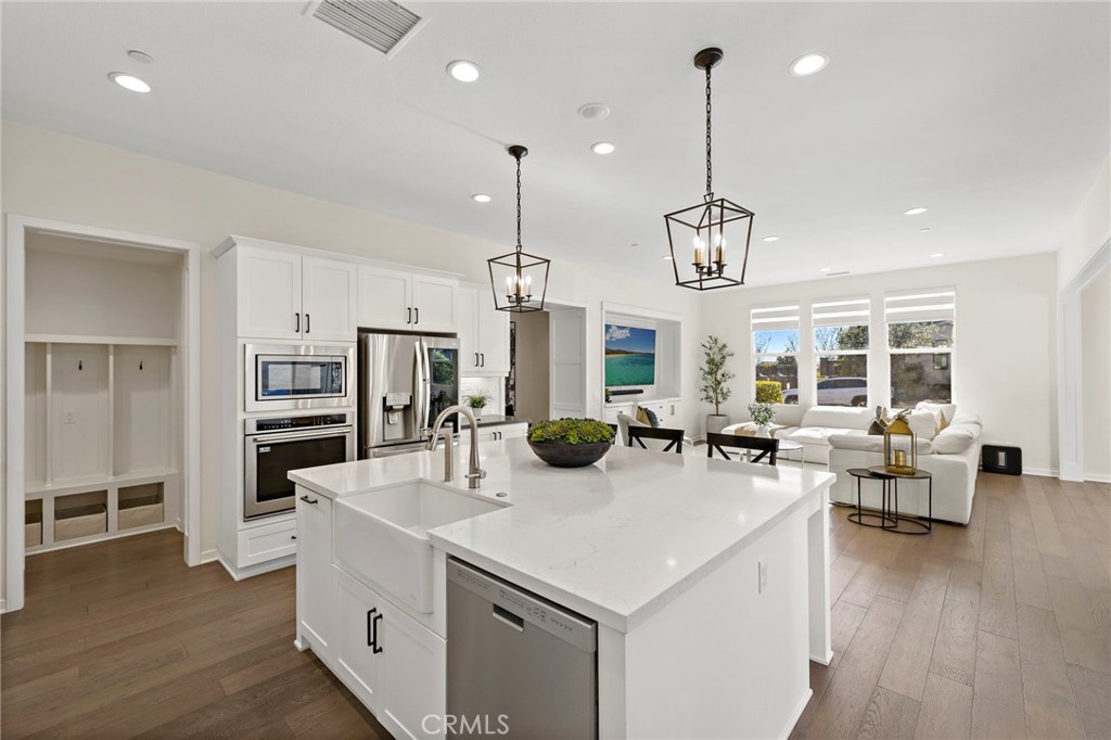 44 Jarano Street Rancho Mission Viejo, CA 92694 - Photo 9 of 65 a kitchen with sink stove and wooden floor