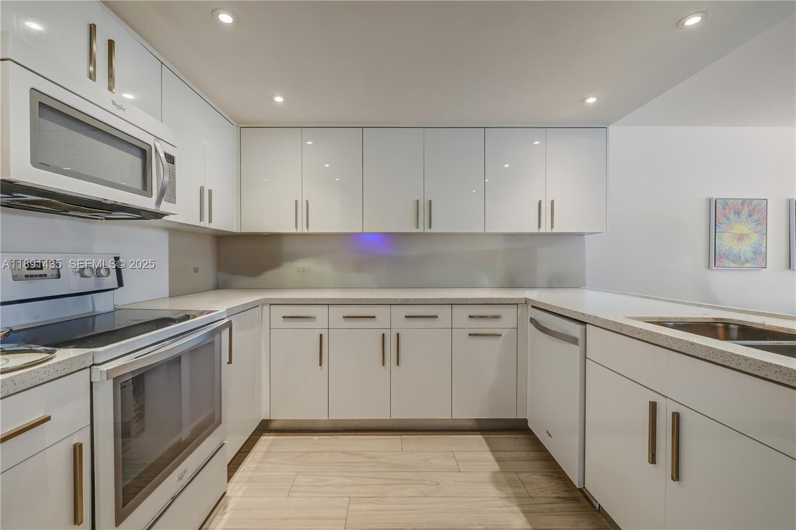 a kitchen with granite countertop cabinets stainless steel appliances and a sink