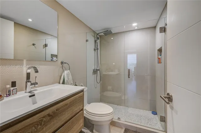 a bathroom with a sink toilet and shower