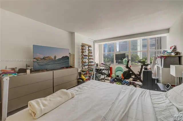 a bedroom with furniture and a large window