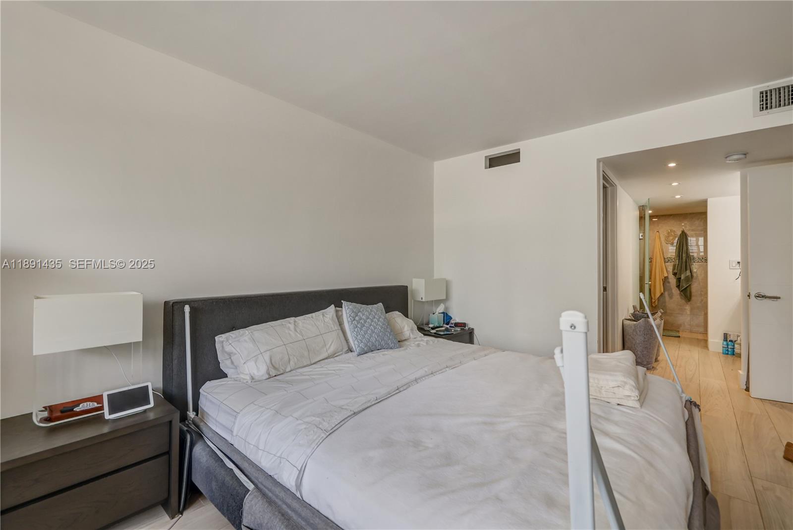 1901 Brickell Avenue, Unit B413 Miami, FL 33129 - Photo 19 of 33 a bedroom with a bed and wooden floor