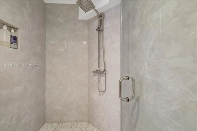 a bathroom with a glass shower door