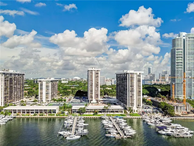 a view of a patio with couches and table and chairs with wooden floor and fence