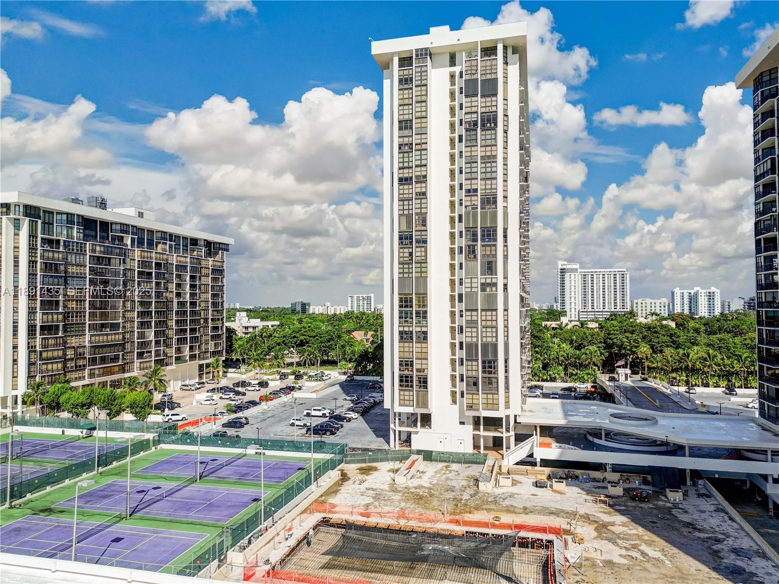 1901 Brickell Avenue, Unit B413 Miami, FL 33129 - Photo 30 of 33 a view of a patio with couches and table and chairs with wooden floor and fence