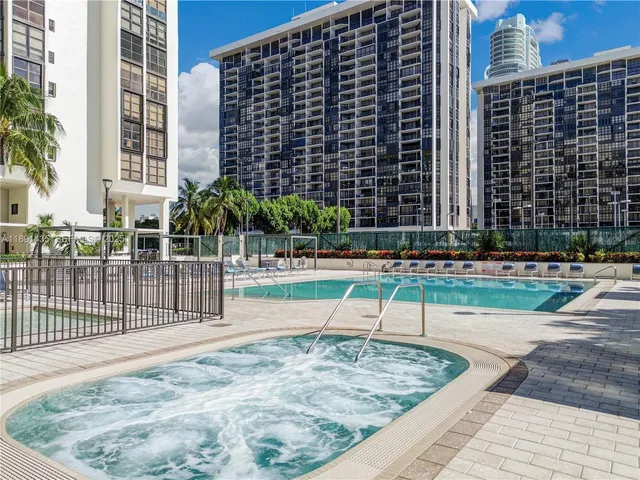 a swimming pool view with outdoor seating