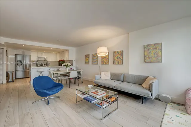 a living room with furniture a rug and a table
