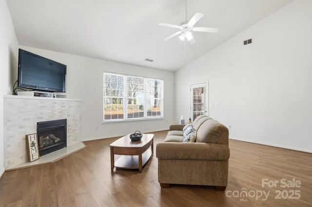 a living room with furniture flat screen tv and a fireplace