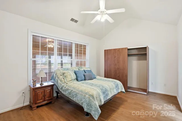 a bedroom with a large bed and a chandelier