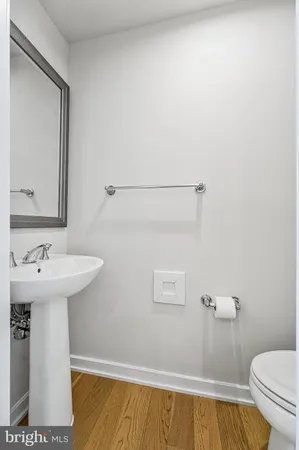 a bathroom with a sink a toilet and mirror