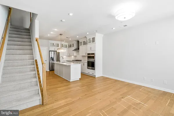 a view of kitchen with wooden floor and electronic appliances