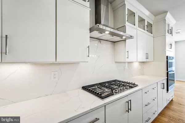 a kitchen with stainless steel appliances a cabinets and a stove top oven