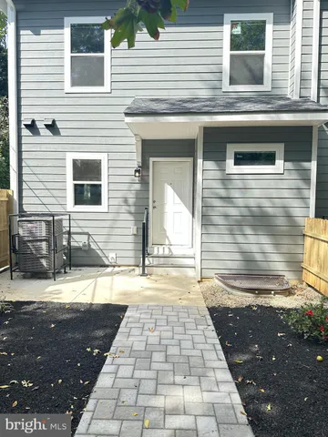 a view of a brick house with a yard