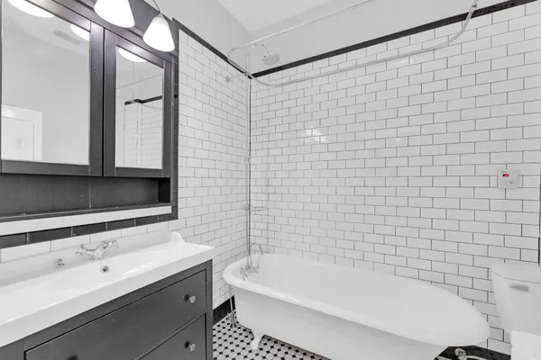 a bathroom with a bathtub and a sink