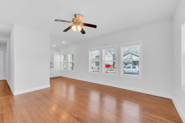 a view of empty room with wooden floor